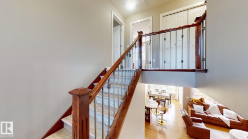Staircase featuring wood railings and metal balusters - 335 62 Street Sw, Edmonton, AB - Indoor Photo Showing Other Room