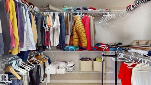 Walk-in closet featuring wire shelving and multiple hanging rods for organization - 335 62 Street Sw, Edmonton, AB - Indoor With Storage