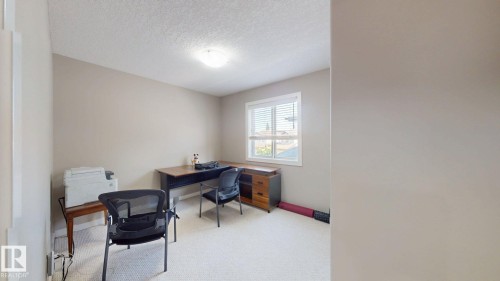 Carpeted room with a single window, white window blinds, and neutral painted walls - 335 62 Street Sw, Edmonton, AB - Indoor Photo Showing Office