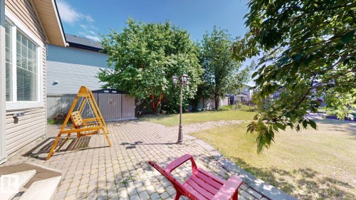 Expansive backyard featuring a paver patio, a freestanding storage shed, and mature trees - 335 62 Street Sw, Edmonton, AB - Outdoor