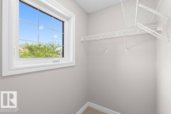 Windowed closet space featuring white wire shelving - 