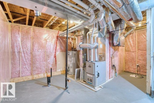 Unfinished basement space featuring exposed wood framing, ceiling joists, and a concrete floor - 1627 167 Street Sw, Edmonton, AB - Indoor Photo Showing Basement