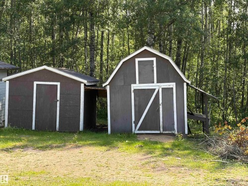 Two detached storage structures with dark siding and white trim - # 501  11131 Twp Rd 600, Rural St. Paul County, AB - Outdoor