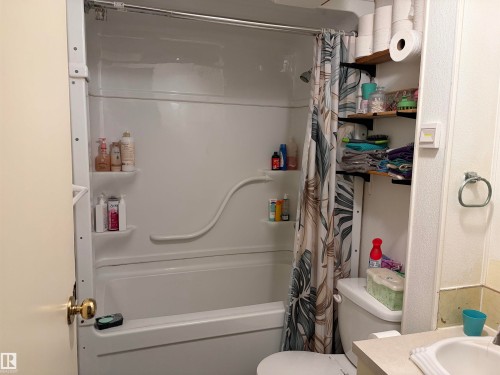 Full bathtub and shower combination unit featuring integrated shelving - # 501  11131 Twp Rd 600, Rural St. Paul County, AB - Indoor Photo Showing Bathroom