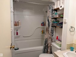 Full bathtub and shower combination unit featuring integrated shelving - 