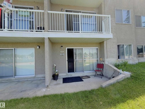 Exterior featuring a ground-level patio and an upper-level balcony with white railings - #108 4501 51 St, Leduc, AB - Outdoor With Exterior