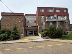 Multi-level building exterior featuring brick and paneling finishes - 