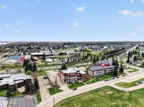 Building exterior featuring brick facade, multiple levels, and balconies - #108 4501 51 St, Leduc, AB - Outdoor With View