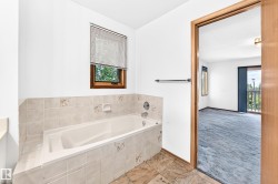Soaking tub with tiled surround and integrated window - 