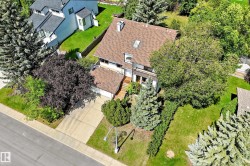 Residential property featuring a shingle roof, a front-facing attached garage, and a concrete driveway - 