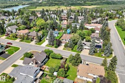 Residential neighborhood featuring mature trees and a curvilinear street design - 
