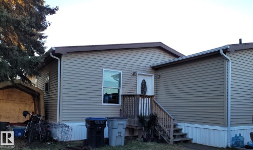 Tan horizontal siding exterior with brown trim - 5273 50 Street, Mayerthorpe, AB - Outdoor With Exterior