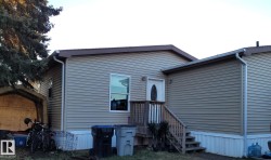 Tan horizontal siding exterior with brown trim - 