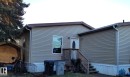 Tan horizontal siding exterior with brown trim - 5273 50 Street, Mayerthorpe, AB  - Outdoor With Exterior 