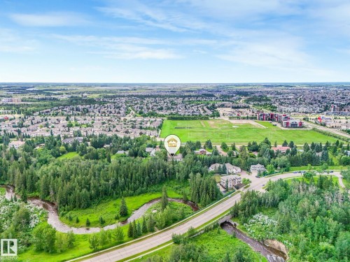 Sprawling community setting featuring extensive green spaces, mature tree coverage, and a meandering creek - 10912 5 Avenue Sw, Edmonton, AB - Outdoor With View