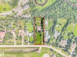 Expansive property featuring a main residence, multiple outbuildings, mature trees, and extensive green space - 