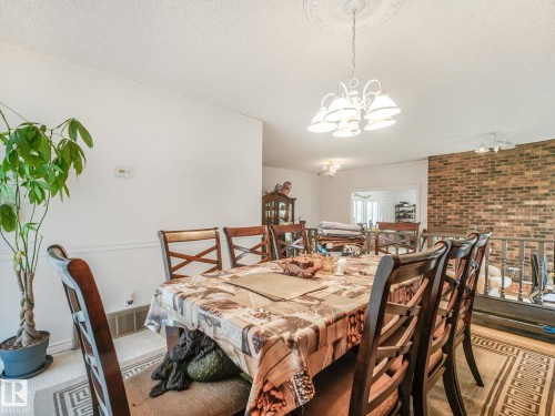 Dining area featuring a decorative ceiling medallion and a white chandelier - 10912 5 Avenue Sw, Edmonton, AB - Indoor Photo Showing Dining Room
