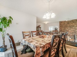 Dining area featuring a decorative ceiling medallion and a white chandelier - 