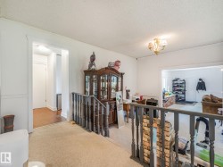 Carpeted landing with painted wood banister - 