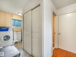 Laundry area featuring a window, built-in cabinetry, and ceramic tile flooring - 