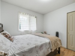 Bright room featuring white walls and wood-finish flooring - 