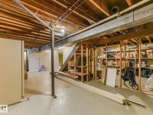 Unfinished basement space featuring exposed wood joists, structural framing, and concrete flooring - 10912 5 Avenue Sw, Edmonton, AB - Indoor Photo Showing Basement