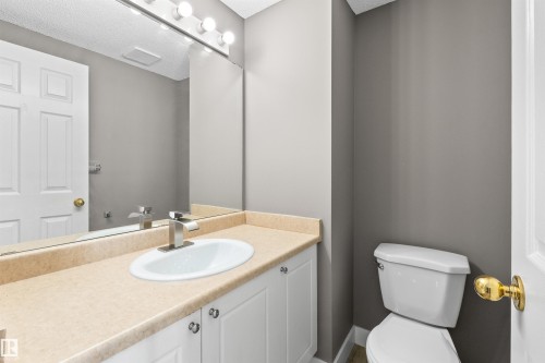 Mainfloor 2-piece bath with new toilet, sink, and faucet. - 6837 159A Avenue Nw, Edmonton, AB - Indoor Photo Showing Bathroom