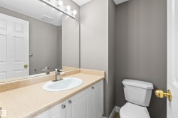 Mainfloor 2-piece bath with new toilet, sink, and faucet. - 