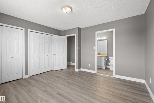 Primary bedroom with two large closets and access to main bathroom - 6837 159A Avenue Nw, Edmonton, AB - Indoor