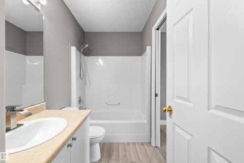 Main bathroom with new sink, faucet, and toilet - 6837 159A Avenue Nw, Edmonton, AB - Indoor Photo Showing Bathroom