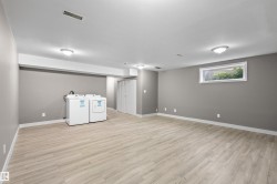 Basement with new vinyl plank floors, a large egress window, and brand new washer and dryer - 
