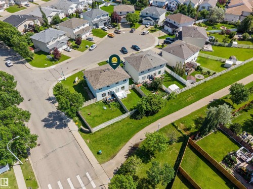 Aerial view of a residential property with a light-colored exterior and a brown shingled roof - 6837 159A Avenue Nw, Edmonton, AB - Outdoor With View