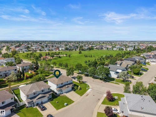 Aerial perspective showcasing a residential neighborhood with a prominent green space - 6837 159A Avenue Nw, Edmonton, AB - Outdoor With View