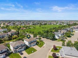 Aerial perspective showcasing a residential neighborhood with a prominent green space - 