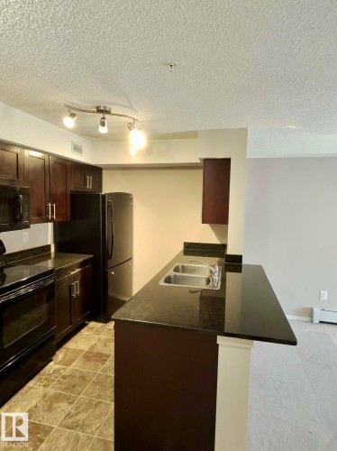 #303 1060 Mcconachie Bv Nw, Edmonton, AB - Indoor Photo Showing Kitchen With Double Sink