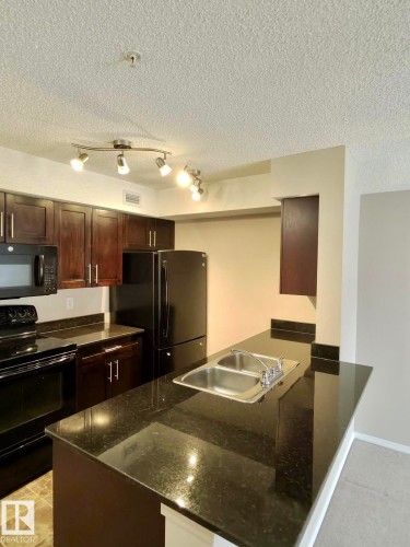 #303 1060 Mcconachie Bv Nw, Edmonton, AB - Indoor Photo Showing Kitchen With Double Sink