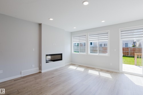 3883 Chrustawka Place Sw, Edmonton, AB - Indoor Photo Showing Living Room With Fireplace