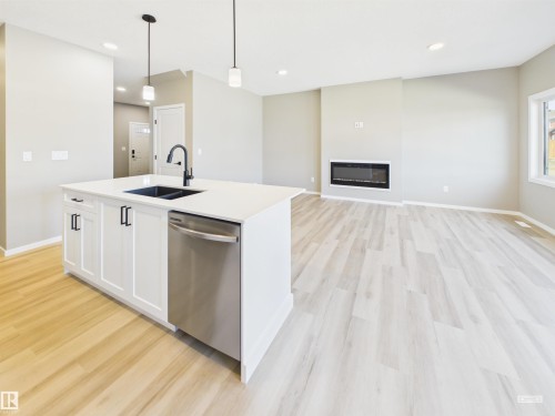 119 Hilton Cove, Spruce Grove, AB - Indoor Photo Showing Kitchen With Fireplace With Double Sink With Upgraded Kitchen