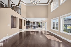Two-story living area featuring dark wood-finish flooring and high ceilings - 