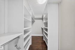 Custom closet system featuring extensive shelving, hanging rods, and built-in storage solutions - 