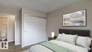 Bedroom featuring neutral wall paint, textured carpeting, and white bi-fold closet doors - 5425 144B Avenue Northwest, Edmonton, AB  - Indoor Photo Showing Bedroom 