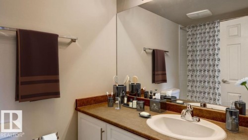 Bathroom vanity with a tan countertop, an oval undermount sink, and chrome fixtures - 5425 144B Avenue Northwest, Edmonton, AB - Indoor Photo Showing Bathroom