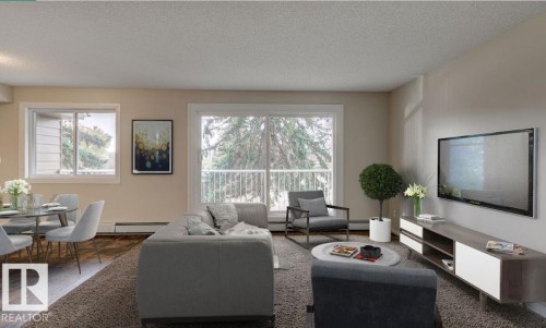 Open-concept living area with wood-finish flooring and a large sliding glass door opening to a balcony - 5425 144B Avenue Northwest, Edmonton, AB - Indoor Photo Showing Living Room