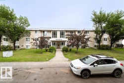Three-story multi-unit building featuring a brick and siding exterior - 