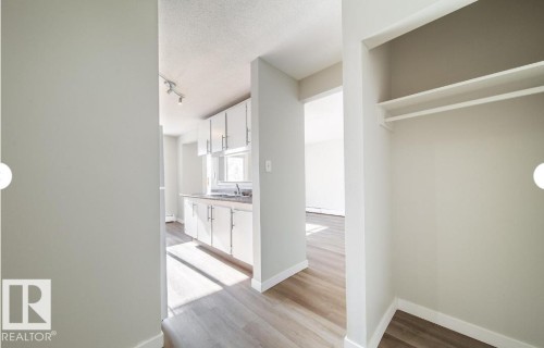 Entryway featuring a built-in closet with shelving and hanging rod - 3312 105 Avenue Northwest, Edmonton, AB - Indoor Photo Showing Other Room