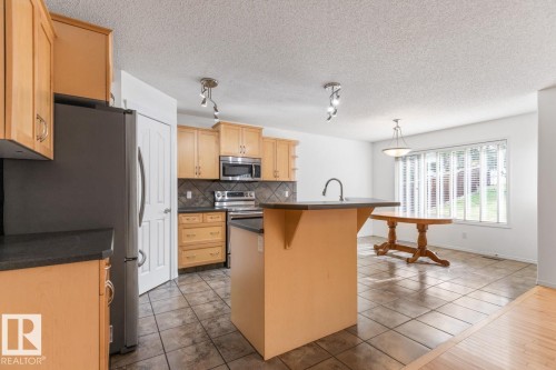 View Of Kitchen And Eating Area. - 4717 60 Street, Beaumont, AB 