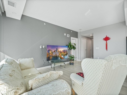 Living area featuring light wood-finish flooring and neutral wall tones - #1501 10180 103 St Nw, Edmonton, AB - Indoor