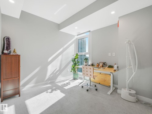 Bright room with a large window, light gray walls, and recessed lighting - #1501 10180 103 St Nw, Edmonton, AB - Indoor Photo Showing Office