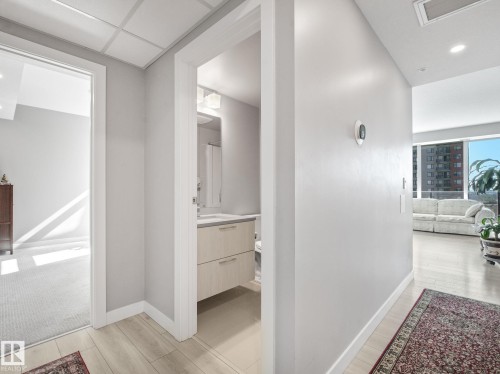 Hallway featuring light wood-finish flooring, recessed lighting, and a white trim package - #1501 10180 103 St Nw, Edmonton, AB - Indoor Photo Showing Other Room