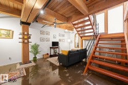 Open-tread wood staircase with black metal railing - 